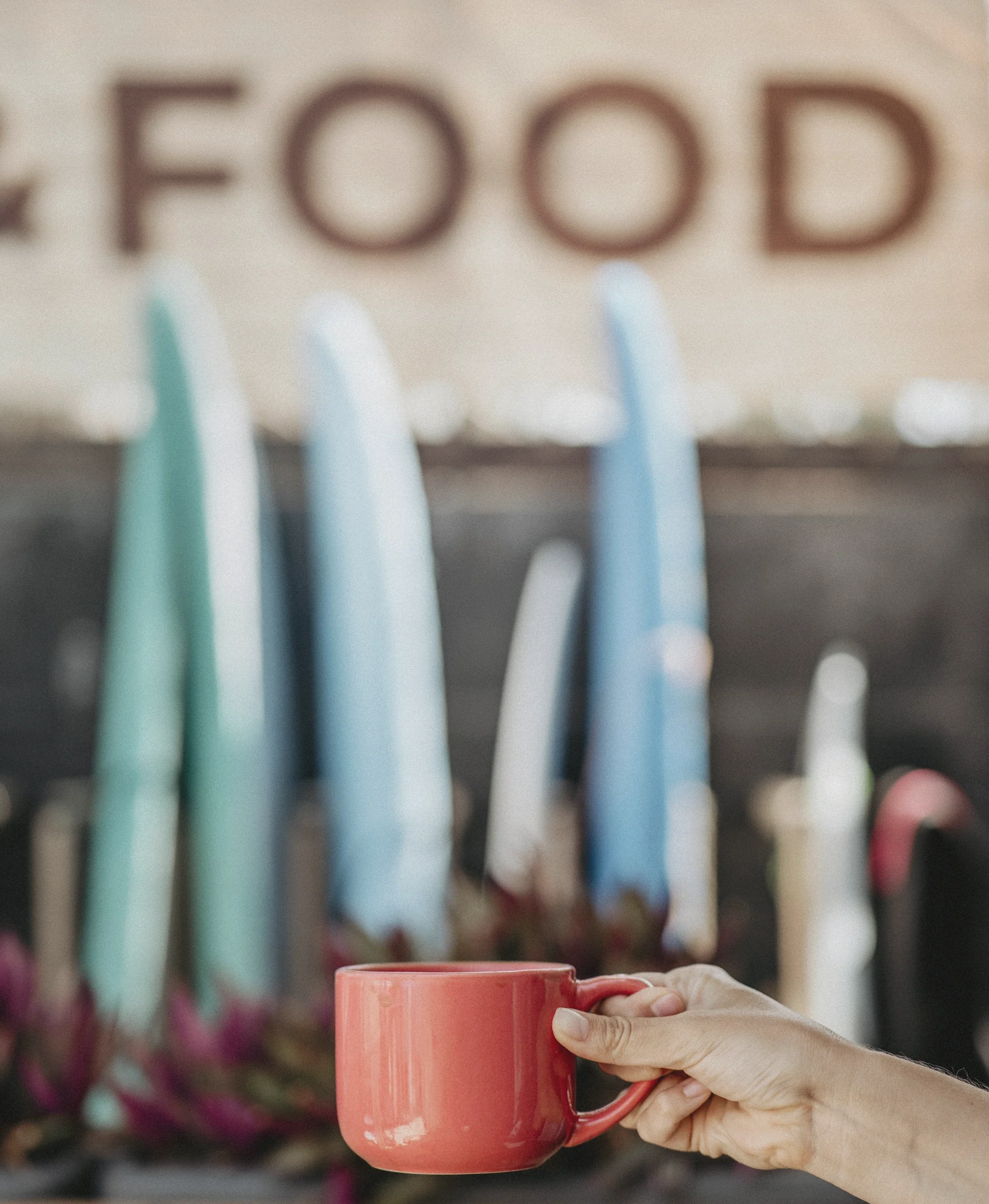 Coffee cup with surfboards at Ocean Freaks Café and Surf School in Las Américas